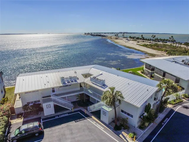 an aerial view of a house with ocean view