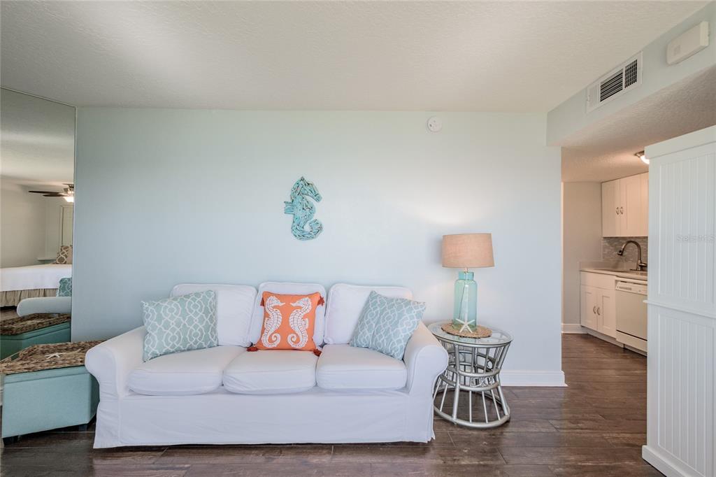2570 Gary Circle, Unit 4 Dunedin, FL 34698 - Photo 12 of 20 a living room with furniture and a lamp