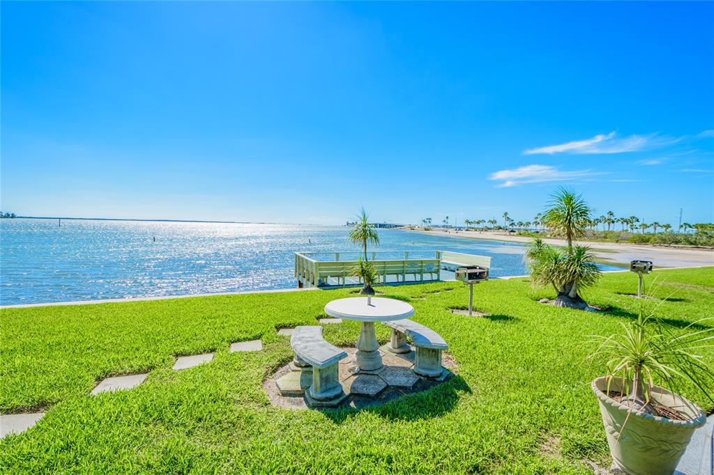 2570 Gary Circle, Unit 4 Dunedin, FL 34698 - Photo 16 of 20 a view of a lake with a big yard