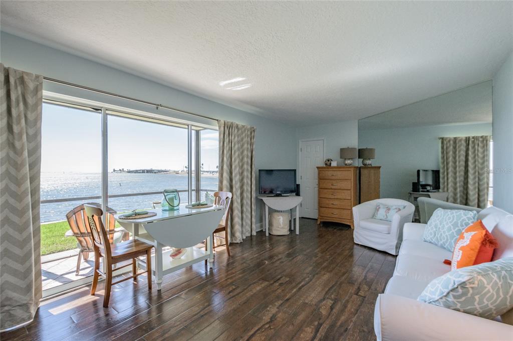 2570 Gary Circle, Unit 4 Dunedin, FL 34698 - Photo 8 of 20 a living room with furniture and a large window