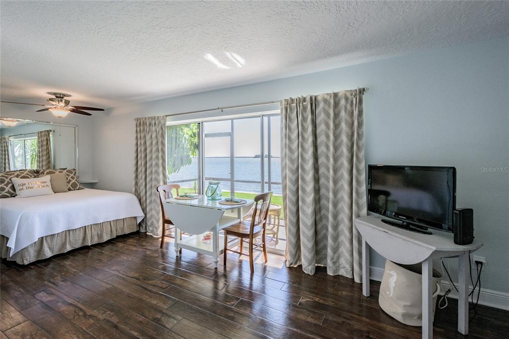 2570 Gary Circle, Unit 4 Dunedin, FL 34698 - Photo 9 of 20 a bedroom with a bed and a flat screen tv