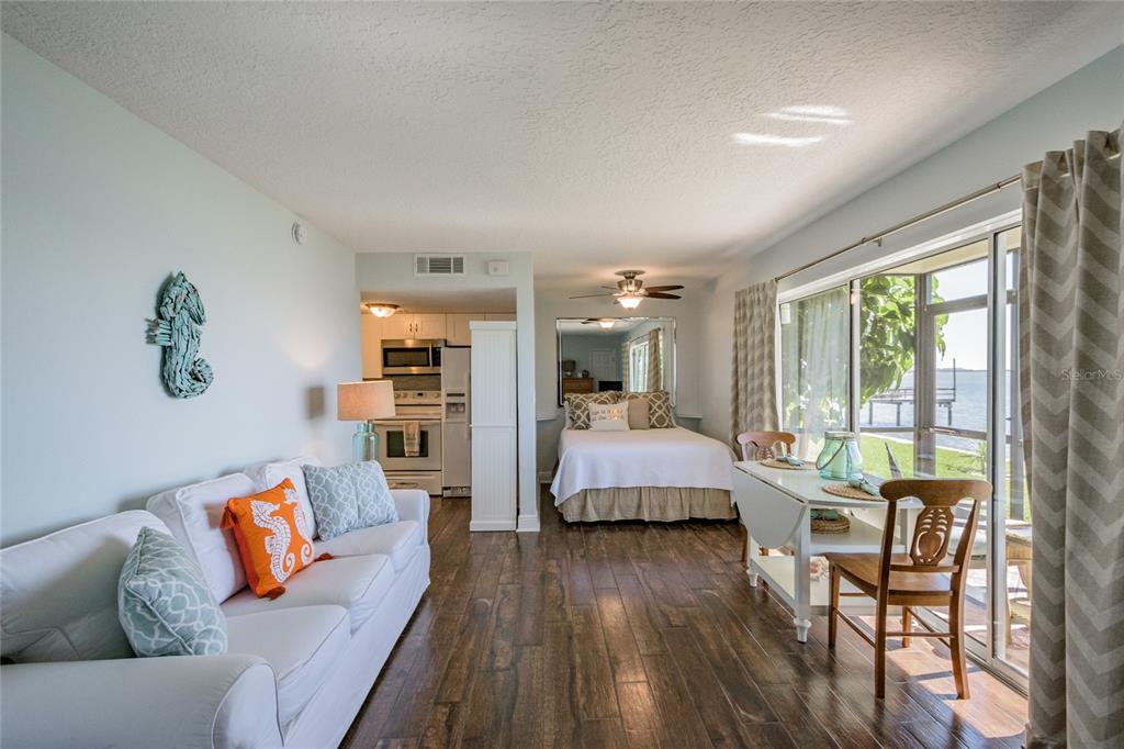 2570 Gary Circle, Unit 4 Dunedin, FL 34698 - Photo 10 of 20 a bedroom with a bed and wooden floor