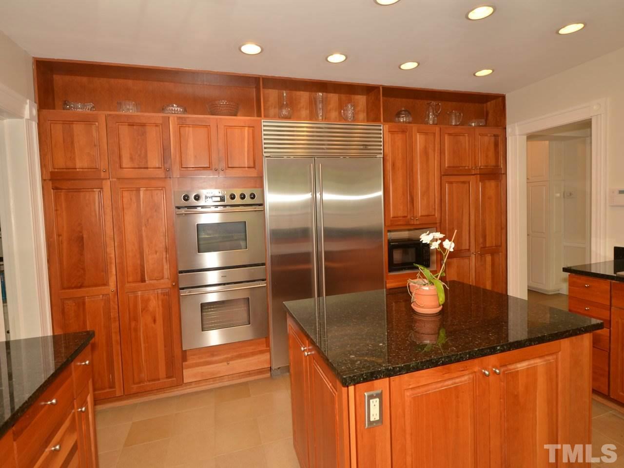 338 Tenney Circle Chapel Hill, NC 27514 - Photo 4 of 25 Lovely kitchen with custom cherry cabinets, granite counters and sink and limestone floors.