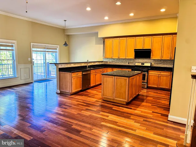 a view of a room with wooden floor and a window