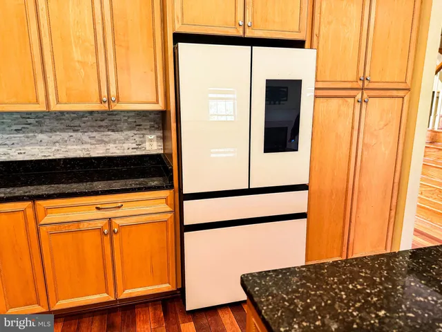 a kitchen with granite countertop cabinets sink and a large window