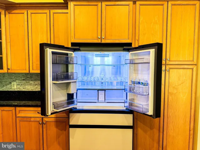 a blue swimming pool with a window and wooden floor
