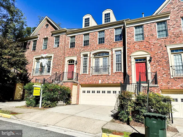 a front view of a residential apartment building with a yard