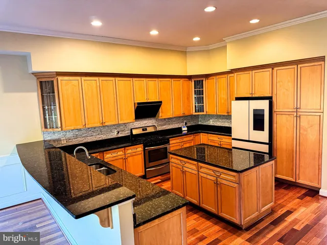 a view of a livingroom with wooden floor and a fireplace
