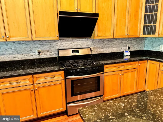 a living room with wooden floors and a fireplace