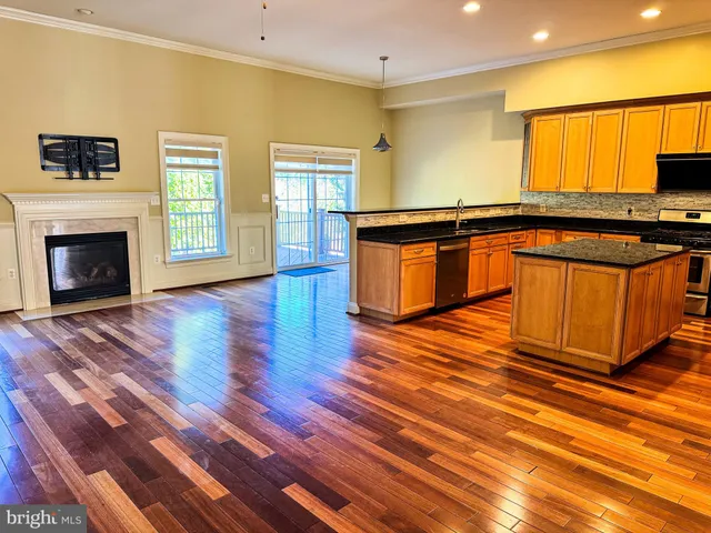 a view of a room with wooden floor