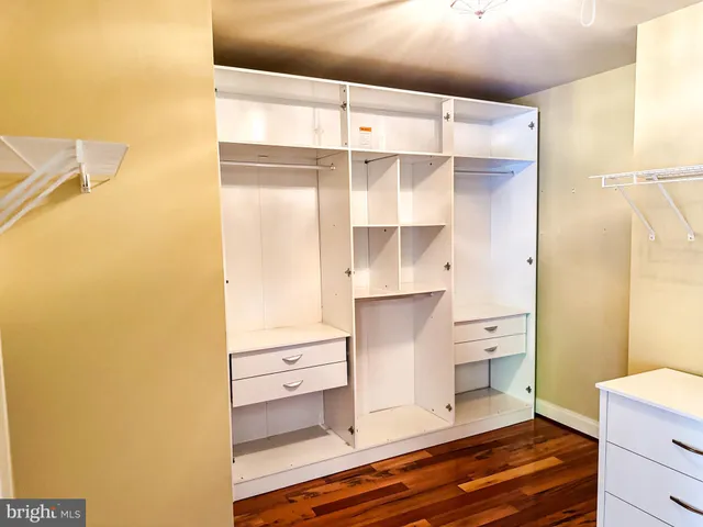 a view of a bedroom with wooden floor