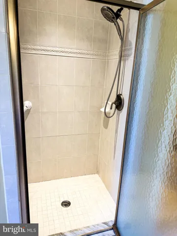 a bathroom with a bathtub and shower