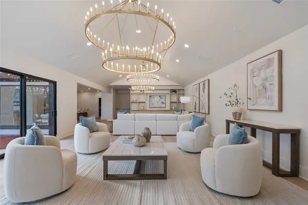a living room with furniture a chandelier and a chandelier