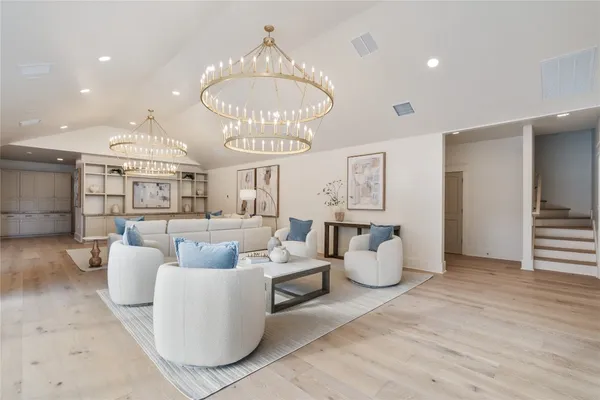 a living room with furniture and a chandelier