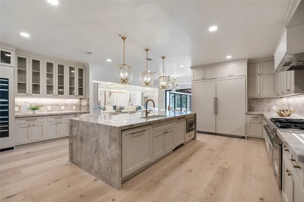 a view of a dining room with furniture wooden floor and chandelier
