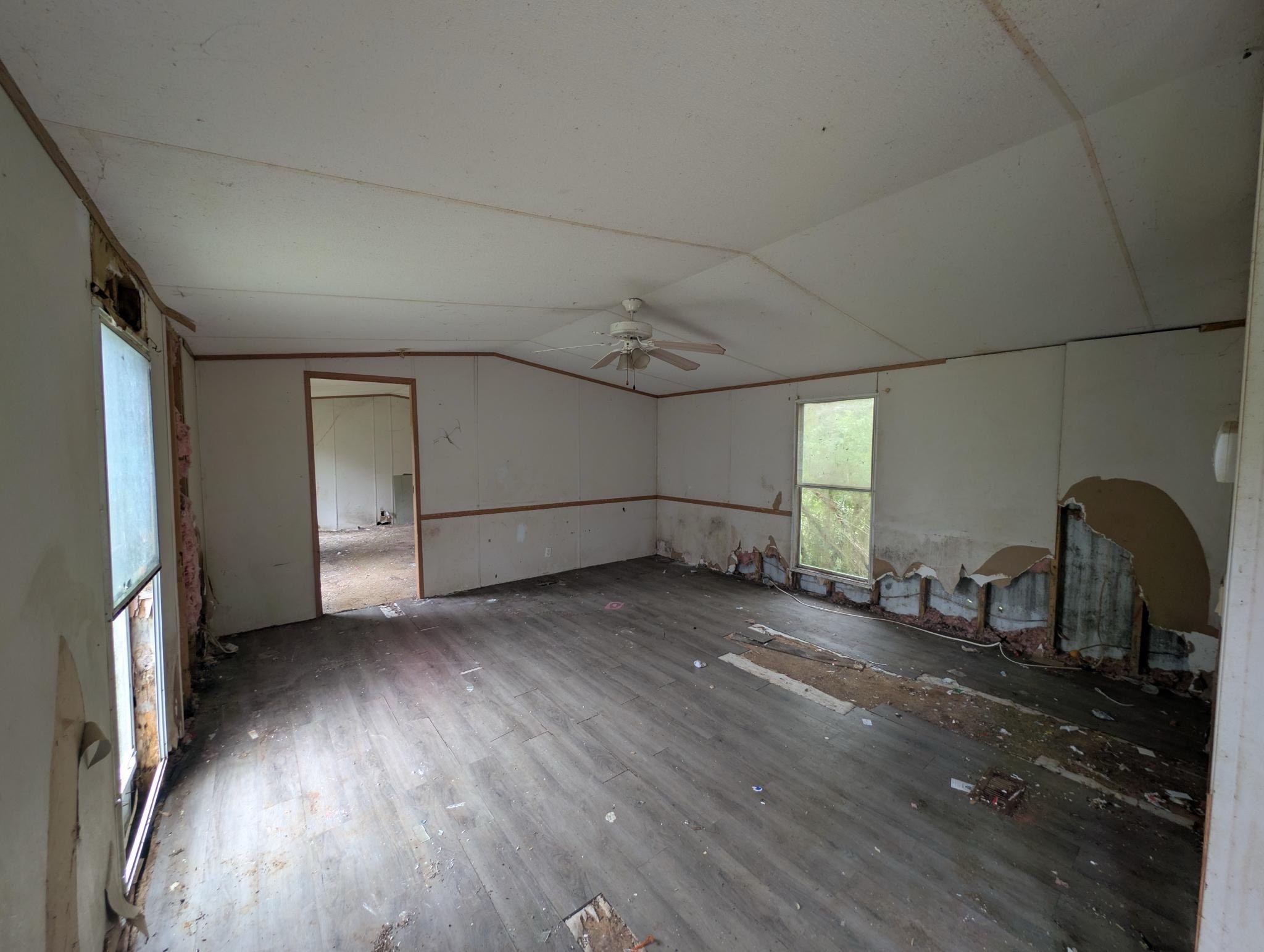 1023 Abiff Road Bon Aqua, TN 37025 - Photo 9 of 14 a view of a livingroom with wooden floor and a ceiling fan