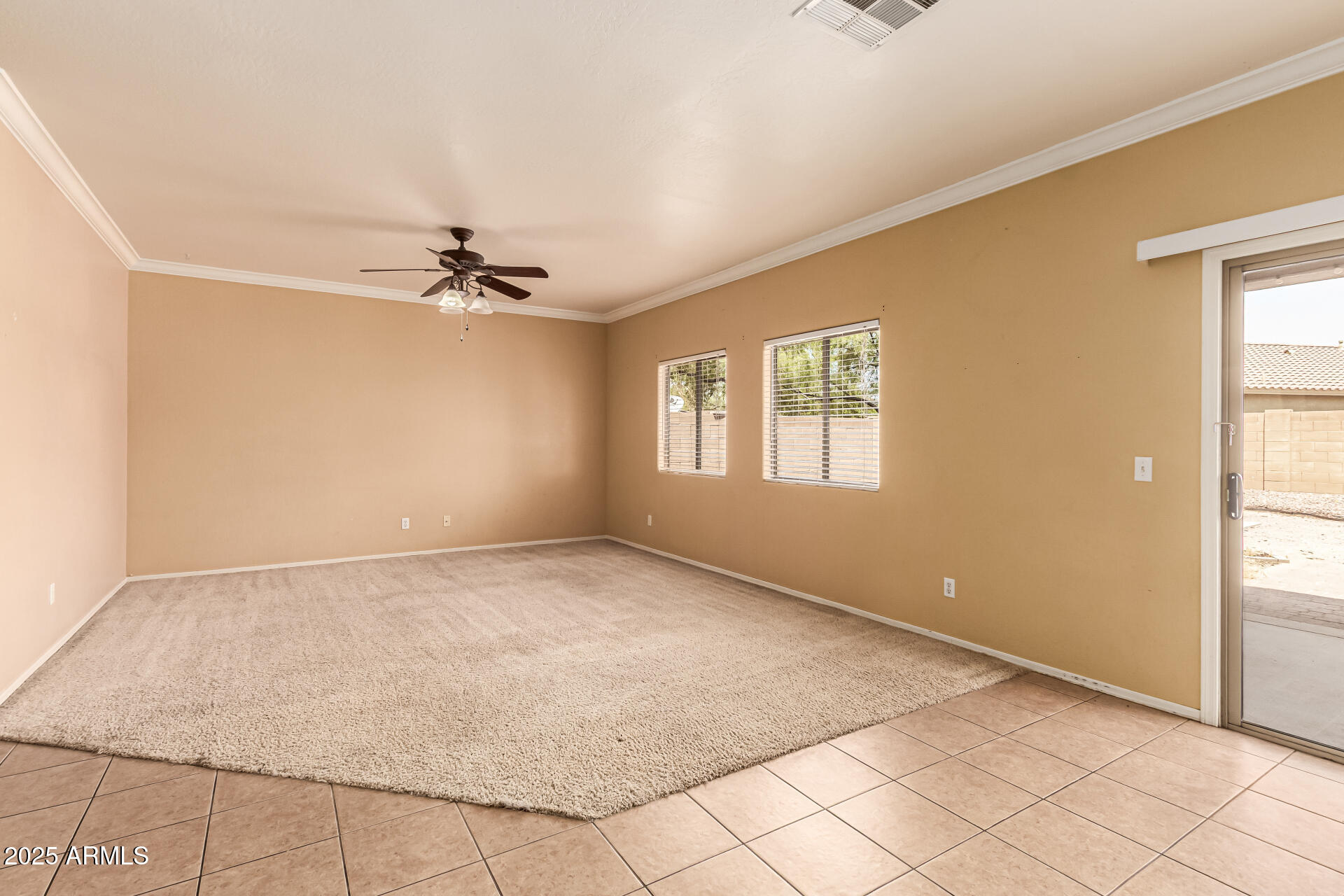 16890 West Rimrock Street Surprise, AZ 85388 - Photo 14 of 28 a view of a livingroom with a ceiling fan and window