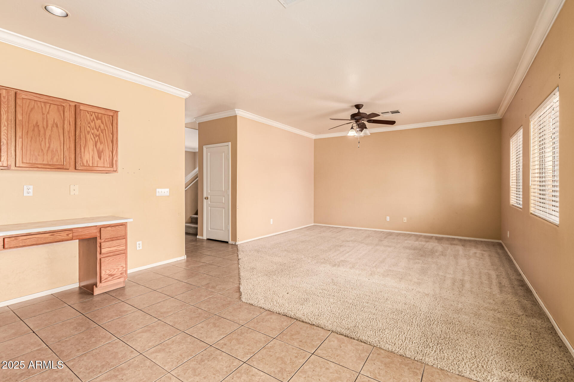 16890 West Rimrock Street Surprise, AZ 85388 - Photo 15 of 28 an empty room with a ceiling fan and windows