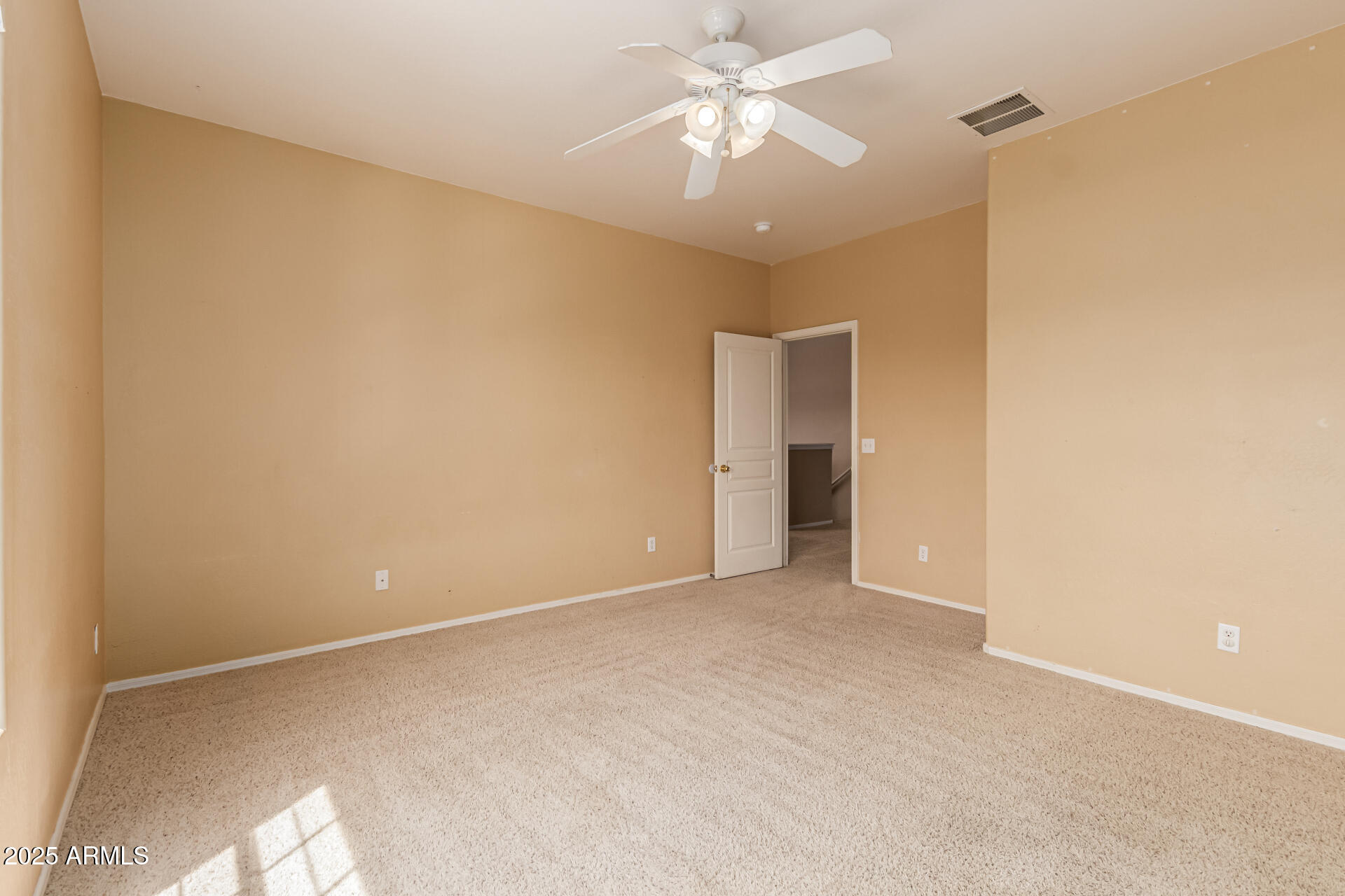 16890 West Rimrock Street Surprise, AZ 85388 - Photo 19 of 28 a view of an empty room with a ceiling fan