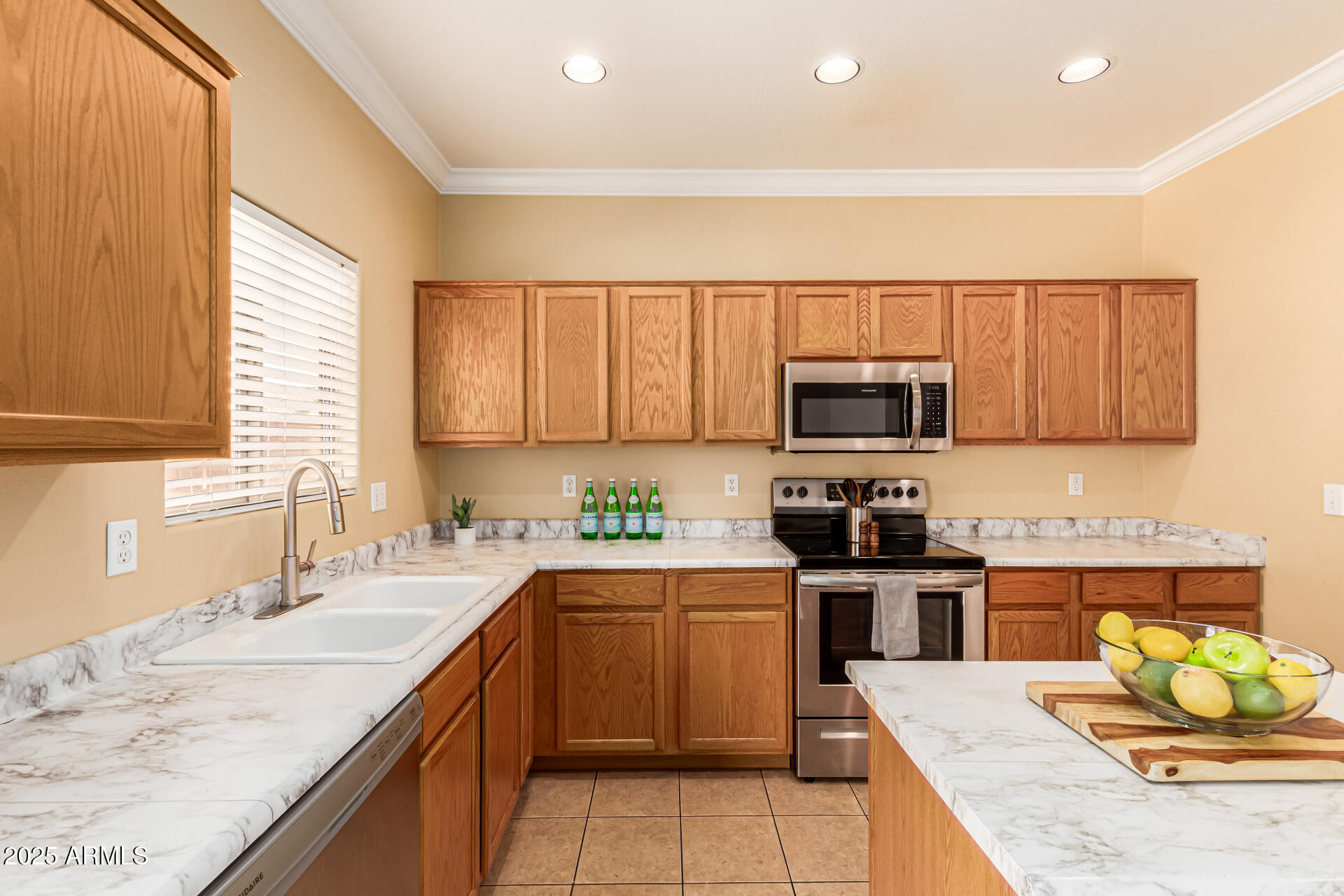 16890 West Rimrock Street Surprise, AZ 85388 - Photo 2 of 28 a kitchen with a sink a stove top oven a counter space and cabinets