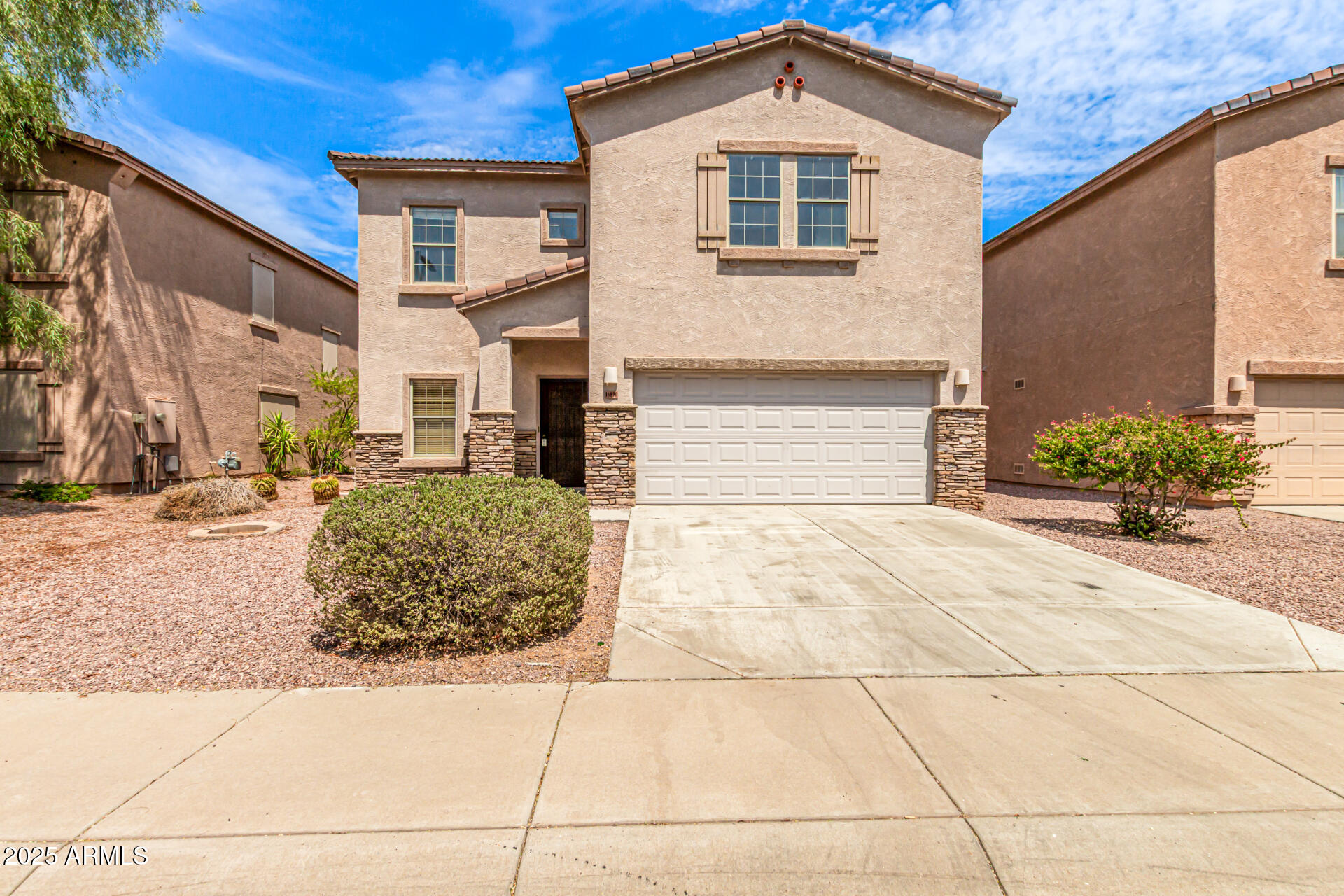 16890 West Rimrock Street Surprise, AZ 85388 - Photo 28 of 28 a front view of a house with a yard