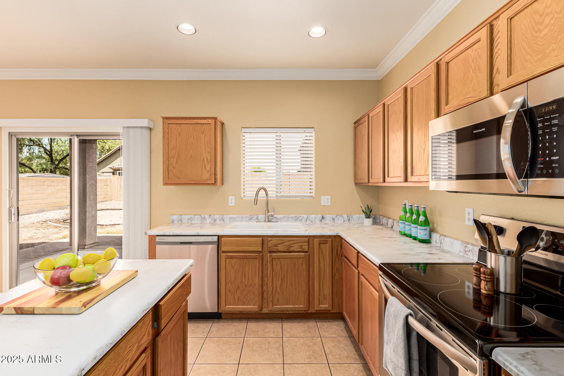 16890 West Rimrock Street Surprise, AZ 85388 - Photo 5 of 28 a kitchen with a sink stove top oven and cabinets