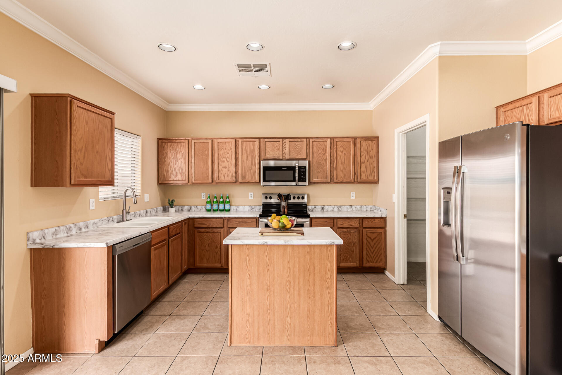 16890 West Rimrock Street Surprise, AZ 85388 - Photo 6 of 28 a kitchen with a sink refrigerator and cabinets