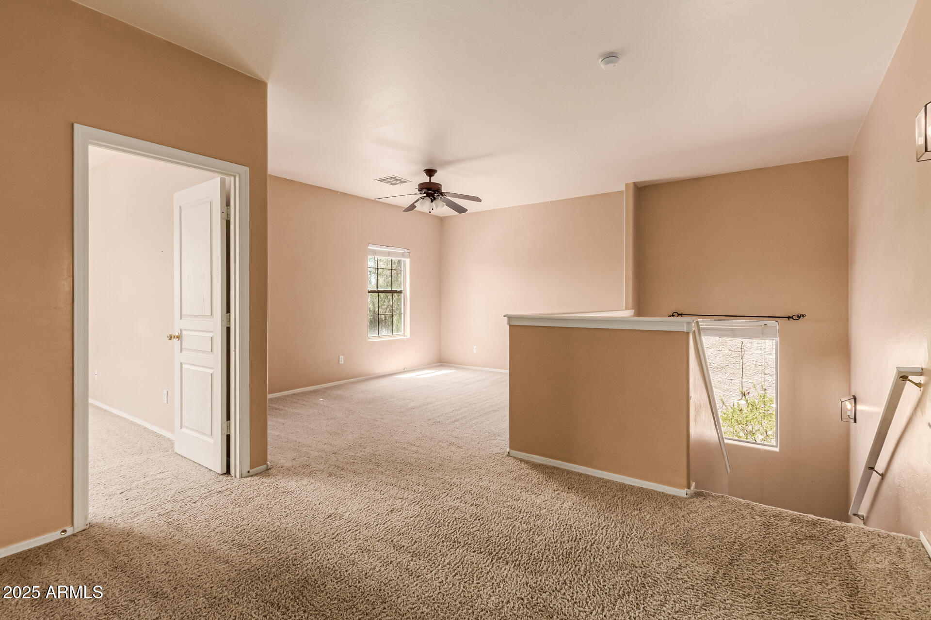 16890 West Rimrock Street Surprise, AZ 85388 - Photo 7 of 28 an empty room with windows and cabinet