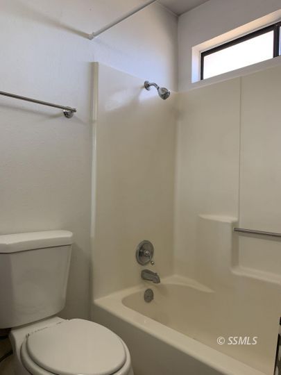 345 South Fountain Street Ridgecrest, CA 93555 - Photo 12 of 24 a white toilet sitting next to a bath tub