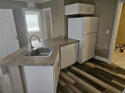 a kitchen with a refrigerator sink and stove