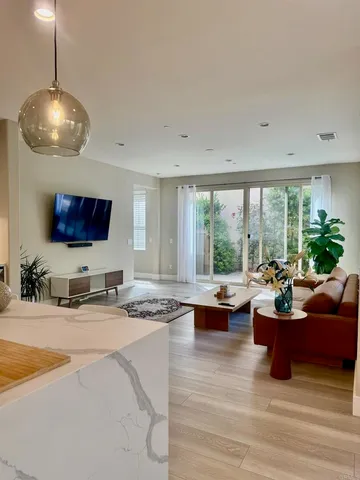 a bedroom with a bed table chair and a window