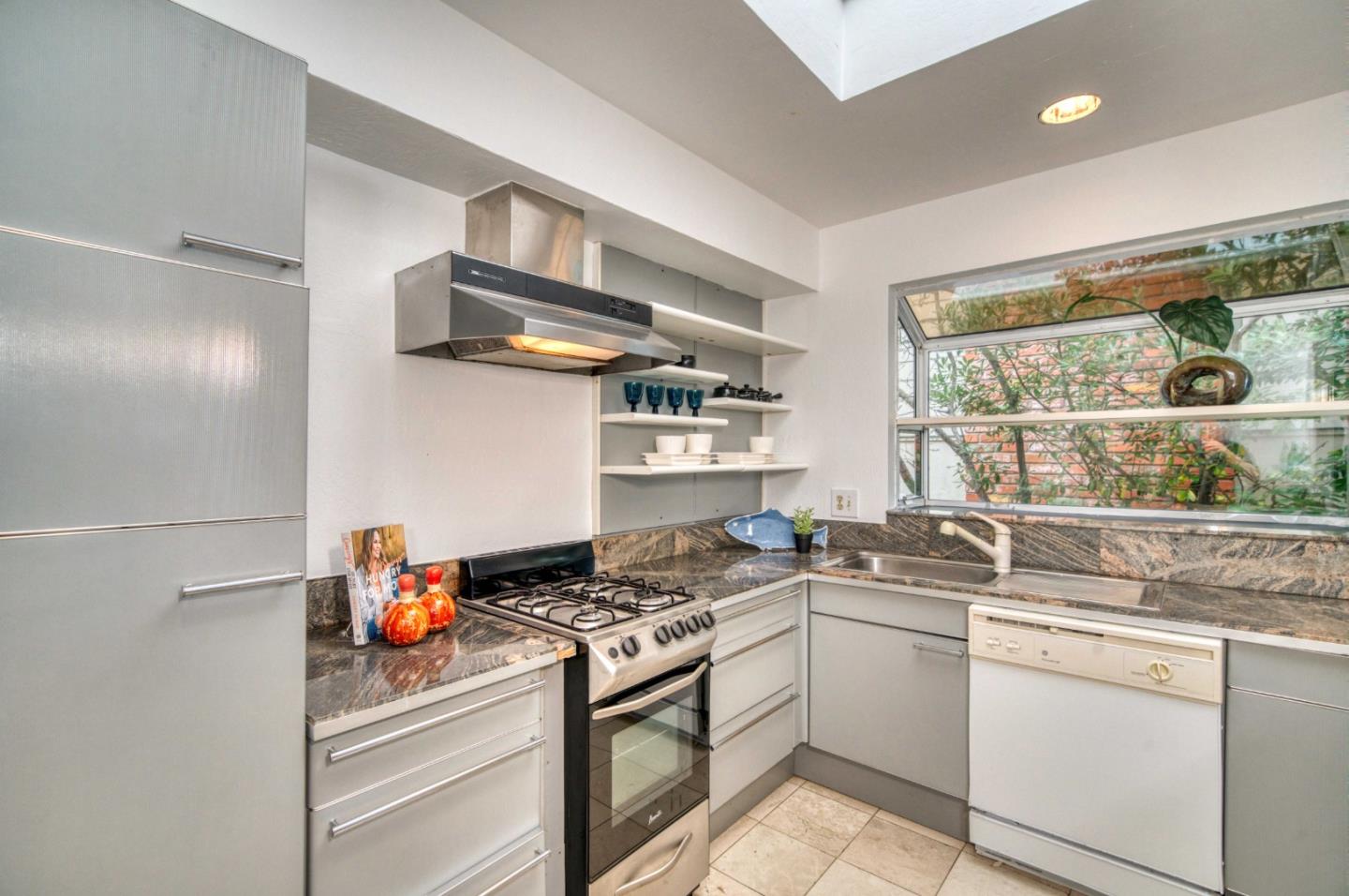 8701 Cabrillo Highway Montara, CA 94037 - Photo 17 of 40 a kitchen with stainless steel appliances a sink stove and window