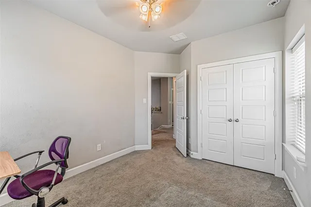 a bed room with bed and window