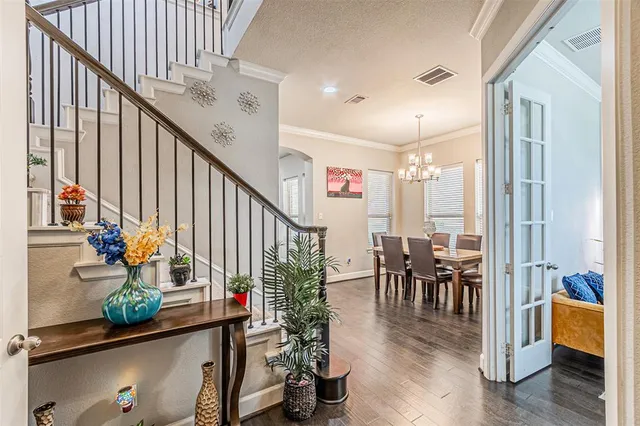 an entryway with wooden floor and furniture