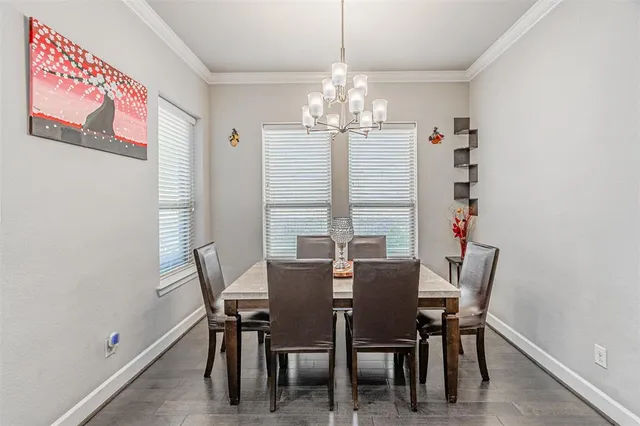 a view of a dining room with furniture and chandelier