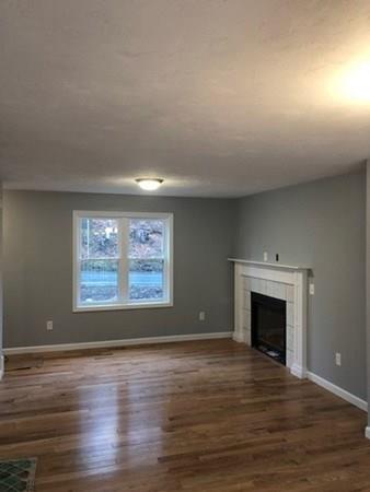 Lot B Cutler Road Jefferson, MA 01522 - Photo 6 of 16 an empty room with wooden floor fireplace and windows