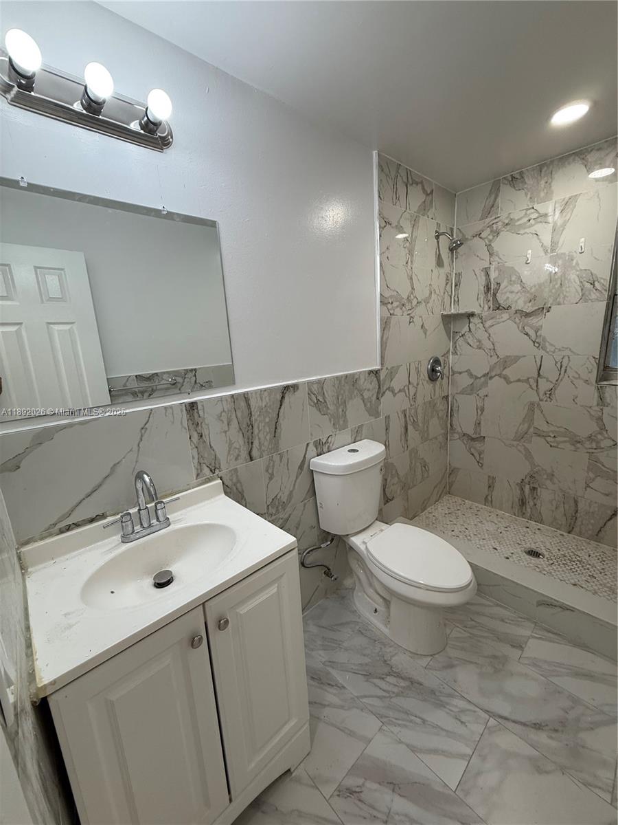1600 West 14th Street Riviera Beach, FL 33404 - Photo 16 of 22 a bathroom with a sink a toilet and shower