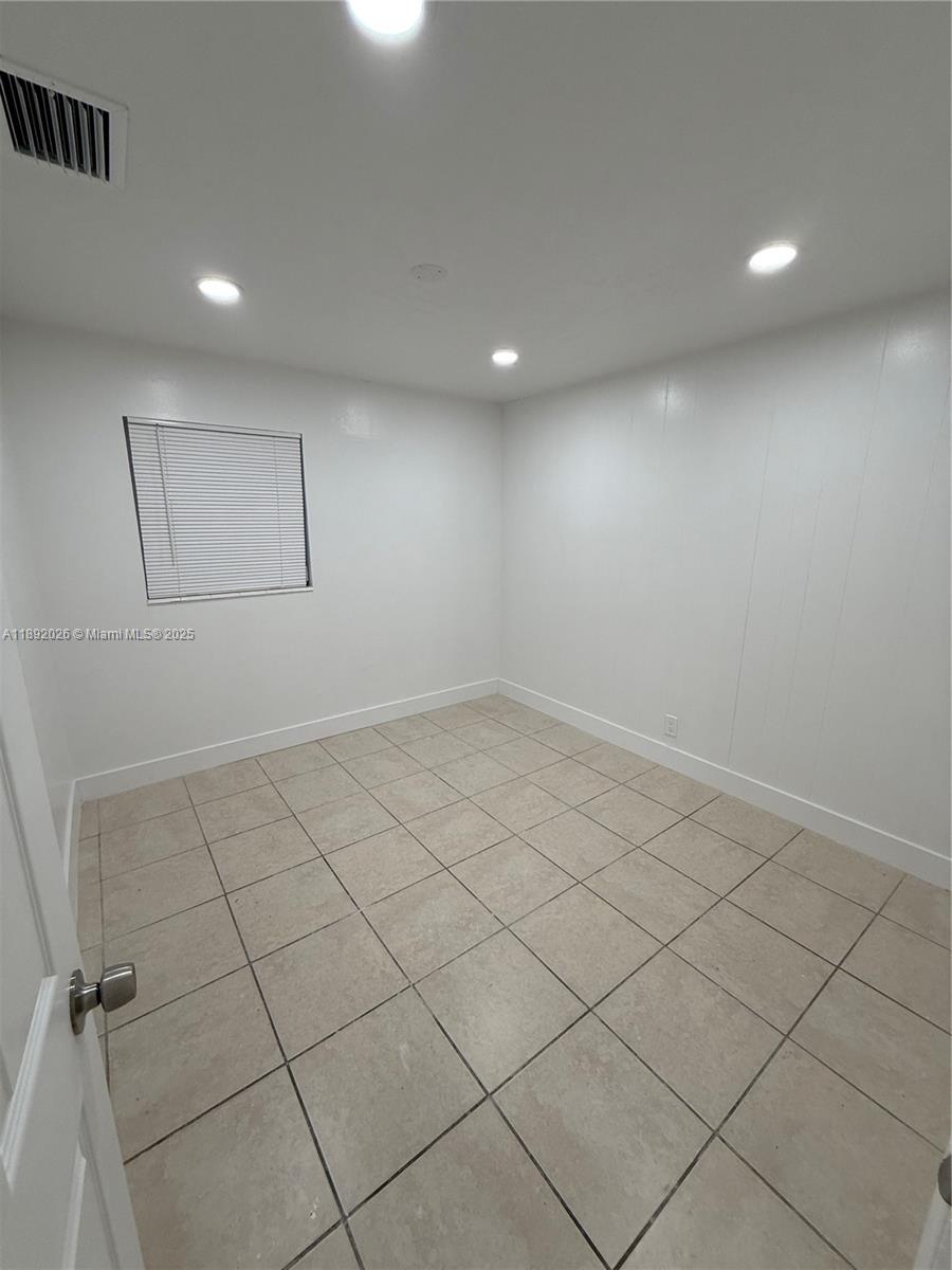 1600 West 14th Street Riviera Beach, FL 33404 - Photo 10 of 22 an empty room with white walls and tiles