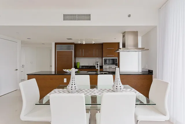 a kitchen with stainless steel appliances granite countertop a stove and a refrigerator