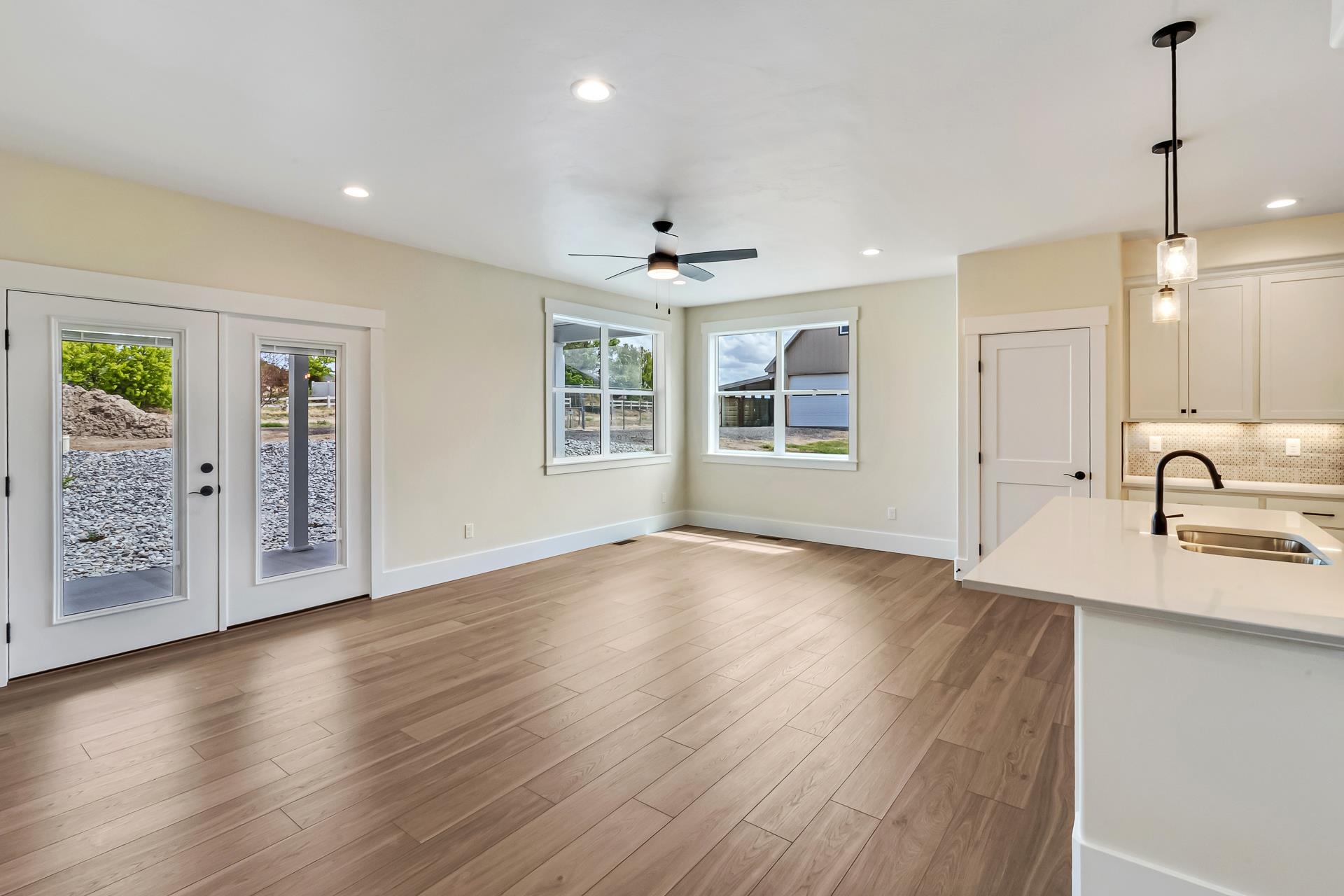 1024 Snowdrop Court Fruita, CO 81521 - Photo 9 of 23 a view of an empty room with a window and wooden floor