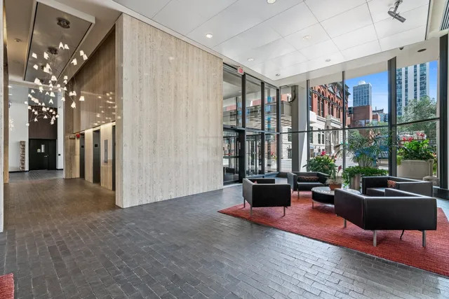 a living room with furniture and large windows