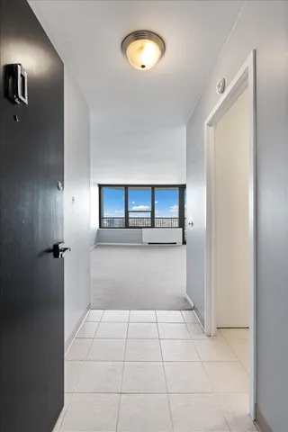 a view of a refrigerator a window and chandelier