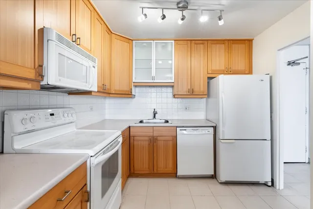 a kitchen with a sink a stove and a refrigerator