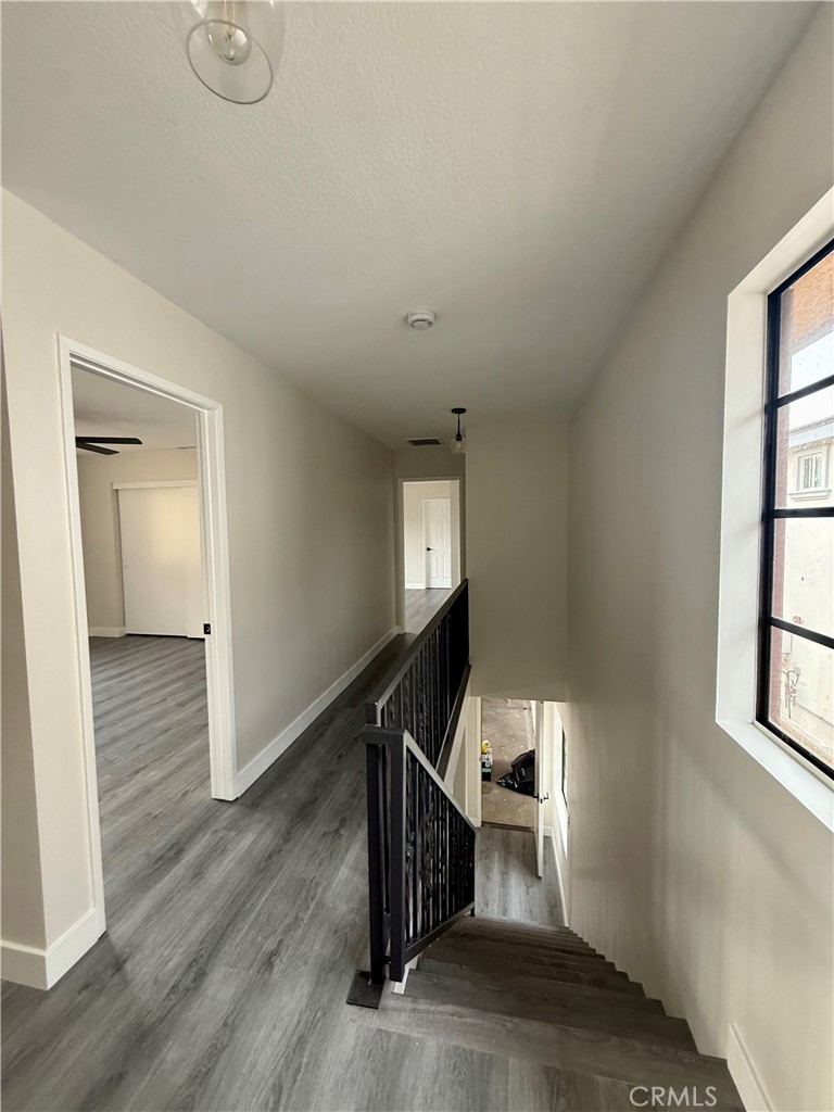 7815 Howe Street, Unit B Paramount, CA 90723 - Photo 12 of 20 a view of a livingroom with wooden floor and stairs