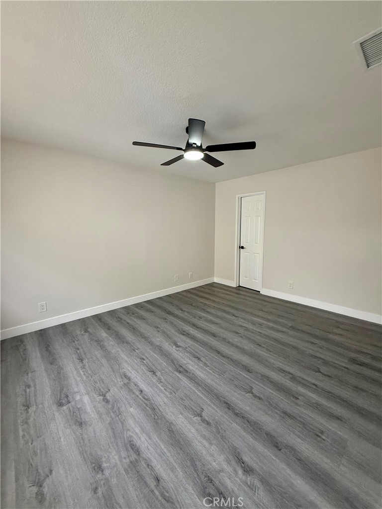 7815 Howe Street, Unit B Paramount, CA 90723 - Photo 13 of 20 a view of empty room with wooden floor