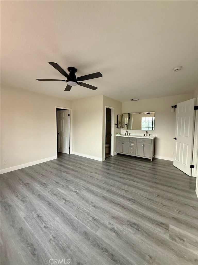7815 Howe Street, Unit B Paramount, CA 90723 - Photo 15 of 20 a view of a livingroom with a ceiling fan and wooden floor