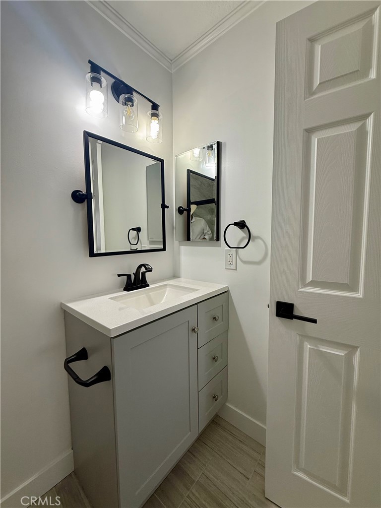 7815 Howe Street, Unit B Paramount, CA 90723 - Photo 18 of 20 a bathroom with a double vanity sink mirror and