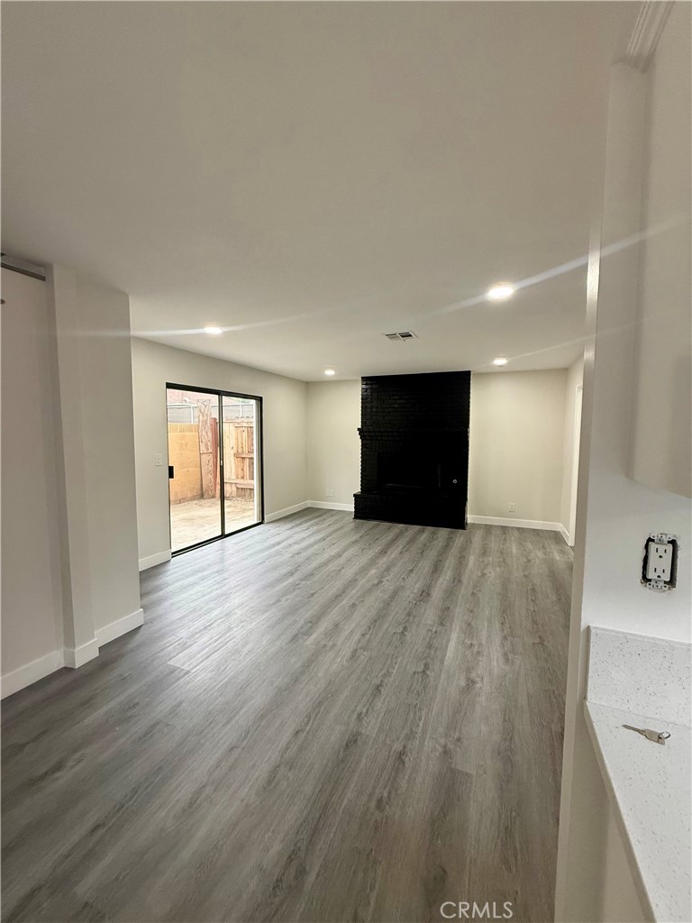 7815 Howe Street, Unit B Paramount, CA 90723 - Photo 5 of 20 a view of empty room with wooden floor