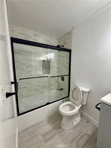 a bathroom with a toilet and a shower