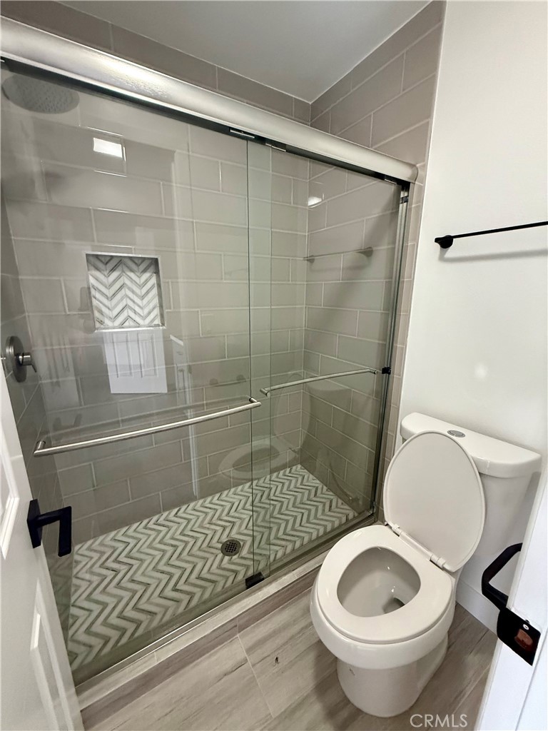 7815 Howe Street, Unit B Paramount, CA 90723 - Photo 9 of 20 a bathroom with a toilet and a shower